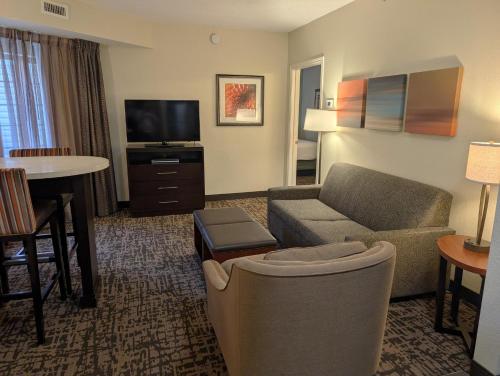 a living room with a couch and a tv at Staybridge Suites Indianapolis-Fishers by IHG in Fishers