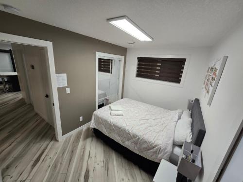 a small bedroom with a bed and a window at Cozy 2 in Regina