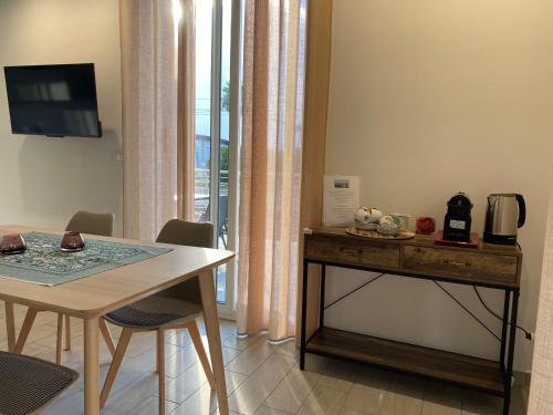 a dining room with a table and a table and chairs at Orizzonte in Loano
