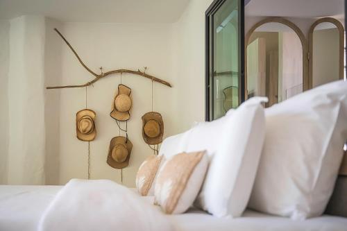 a white couch with white pillows and a mirror at Villa De Leaf River Kaeng Krachan in Phetchaburi