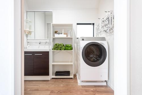 a laundry room with a washing machine and a sink at Ici Japon Village in Tokyo