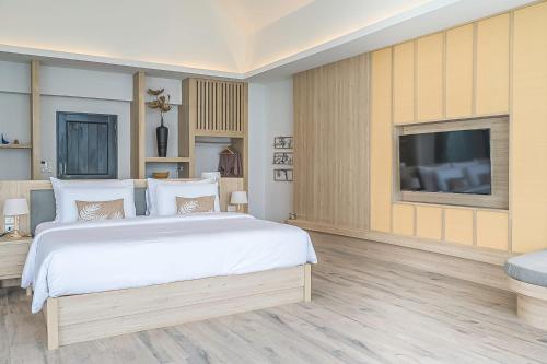 a bedroom with a large bed and a flat screen tv at Villa De Leaf River Kaeng Krachan in Phetchaburi