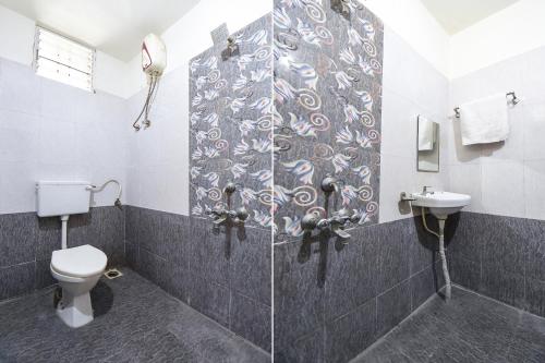 a bathroom with a shower with a toilet and a sink at FabExpress Comfort Executive - Nr Butterfly Park - Hinjawadi in Pune