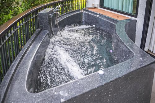 a pool of water in a sink on a balcony at Villa De Leaf River Kaeng Krachan in Phetchaburi