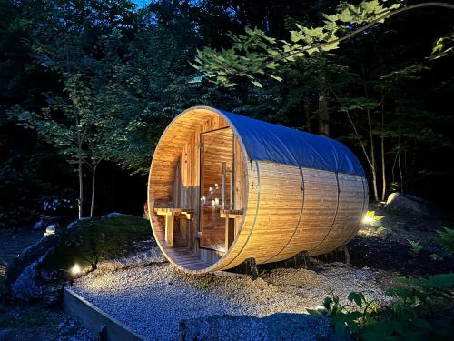 a wooden hobbit house in a forest at night at The Aurora Inn & Cottages in Bartlett
