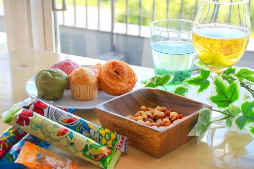 a table with a box of food and a glass of wine at Hotel&Resort Yamanouchi Hills in Yamanouchi
