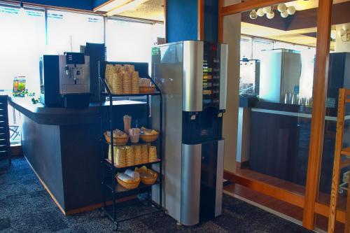 a kitchen with a refrigerator with baskets of food at Hotel&Resort Yamanouchi Hills in Yamanouchi