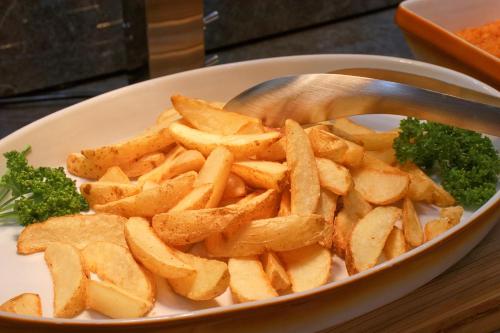 a bowl of french fries with a spoon in it at Hotel&Resort Yamanouchi Hills in Yamanouchi