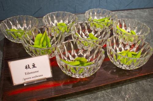 four glass bowls filled with green bananas on a table at Hotel&Resort Yamanouchi Hills in Yamanouchi