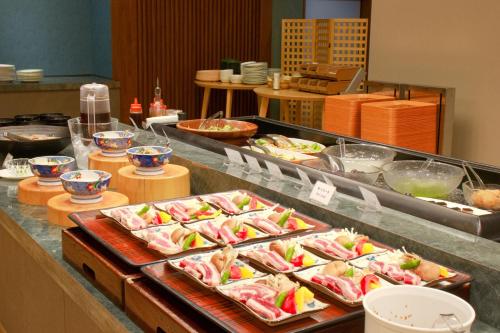 a buffet line with many different types of food at Hotel&Resort Yamanouchi Hills in Yamanouchi