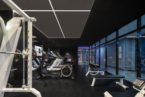 a gym with treadmills and machines in a room at Atour Hotel Suzhou Wuzhong Taihu New Town in Suzhou