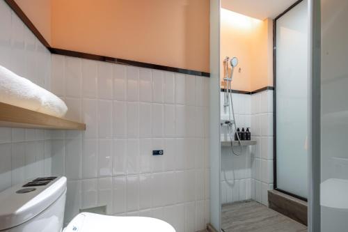 a bathroom with a toilet and a shower at Atour Hotel Suzhou Wuzhong Taihu New Town in Suzhou