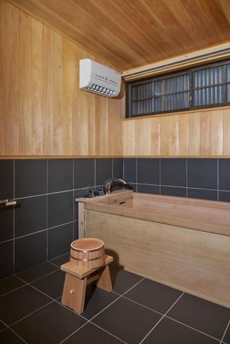 a bathroom with a toilet and a sink at NIPPONIA HOTEL Ozu Castle Town in Ōzu