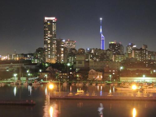 a city skyline at night with a river and buildings at Hotel Marinoa Resort Fukuoka in Fukuoka