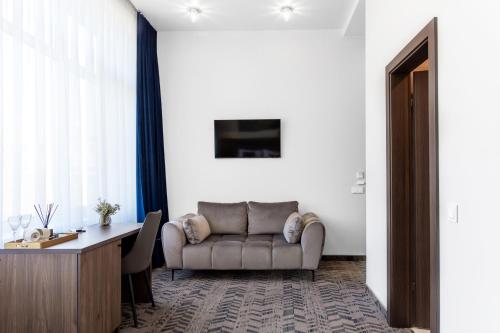 a living room with a couch and a table at AN Hotel self check-in in Šiauliai