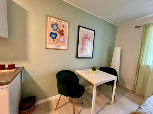 a small room with a table and two chairs at 5minute walk to LEGO House - n9 - garden on site in Billund
