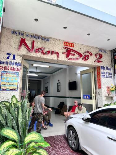 a group of people sitting in a room with a car at Nam Đô Hotel Cần Thơ Downtown in Can Tho
