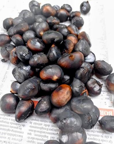 a pile of black potatoes sitting on top of a newspaper at Chalet du soleil in Odecla