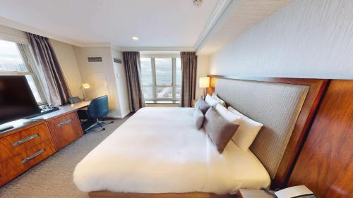 a hotel room with a large bed and a television at Hilton Chicago in Chicago