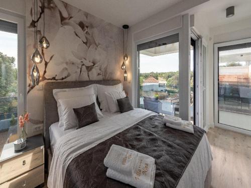 a bedroom with a large bed and a large window at Villa Nina in Croatia near the Adriatic Coast in Zaton