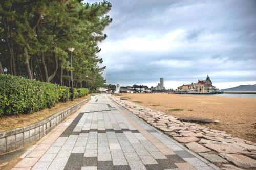 a cobblestone walkway on a beach with trees at Hakata Marine Hotel in Fukuoka