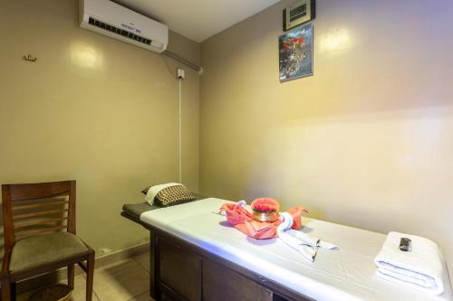 a baby sitting on a bed in a room at Atithi Resort & Spa in Pokhara
