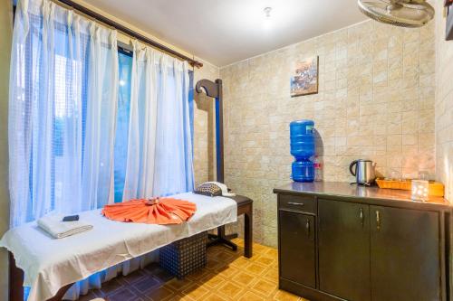 a room with a bed and a counter and a window at Atithi Resort & Spa in Pokhara