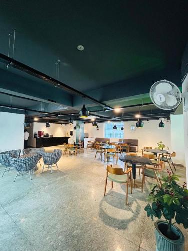 a group of tables and chairs in a room at Wild Wings Premium Hotel in Hyderabad