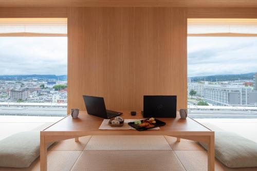 a room with a desk with two laptops and a large window at Tokyu Vacations Fujisan Mishima in Mishima