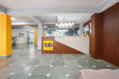 a lobby with a ibid huts sign on a counter at FabHotel New Journey Hospitality Near MG Road & Sikanderpur Metro in Gurgaon