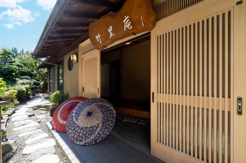 a building with two umbrellas sitting on a patio at Kur and Hotel Shinshu in Shiojiri