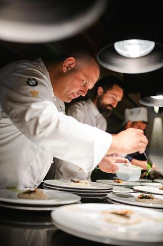 a group of chefs in a kitchen preparing food at Isabella Island Resort, Valamar Collection in Poreč