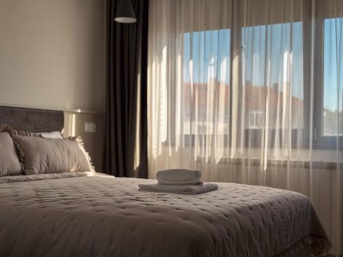 a bedroom with a bed with a hat on it at Dariq in Kazanlŭk