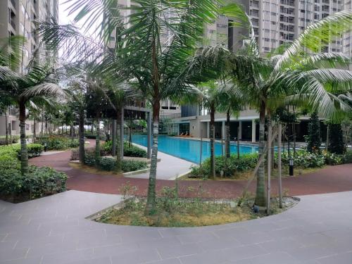 a courtyard with palm trees in front of a building at D'Leisya Studio Youth City Nilai in Nilai