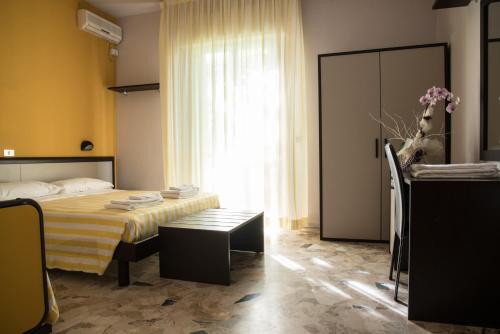 a hotel room with a bed and a window at Hotel Mirage in Bellaria-Igea Marina