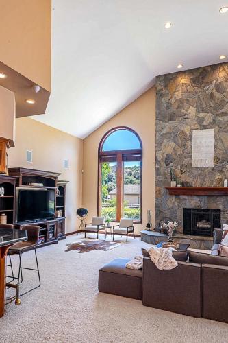 a large living room with a large stone wall at The Oaktree Estate by Fieldtrip 7 Acre Private Resort with Lake Pool Vineyard in Lake Elsinore