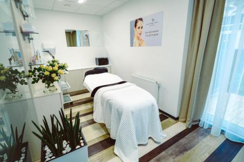 a dressing room with a white blanket on a table at Grand Baltic Dunes Hotel & SPA in Palanga