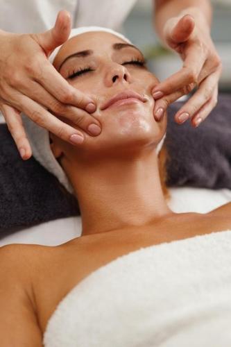 a woman getting her face washed at a spa at Grand Baltic Dunes Hotel & SPA in Palanga