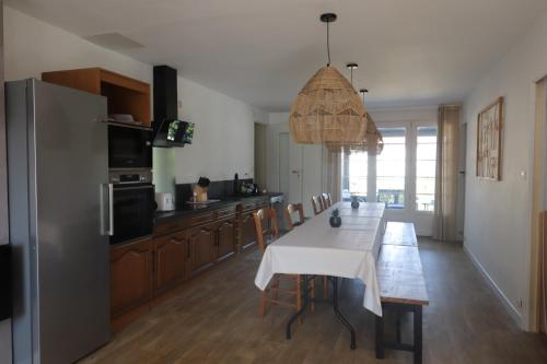 a kitchen with a table with a white table cloth at Gite à la campagne 4 étoiles - 200m2 in Sailly