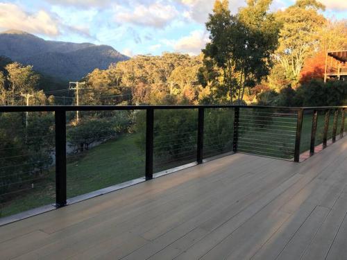 a large deck with a view of the mountains at Watsons in Merrijig