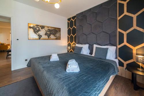 a bedroom with a large bed with two towels on it at Urban Cozy Apartments Zagreb in Zagreb