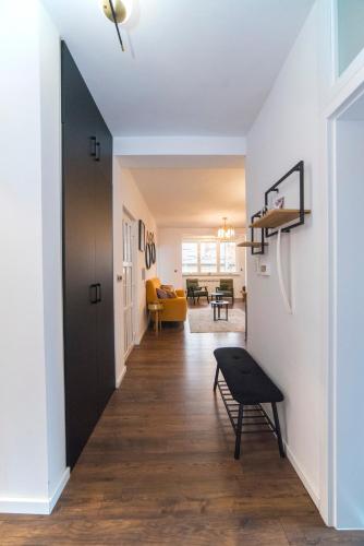 a hallway with a black door and a living room at Urban Cozy Apartments Zagreb in Zagreb