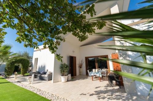 a patio of a house with a table and chairs at Oasi della pace in Bisceglie