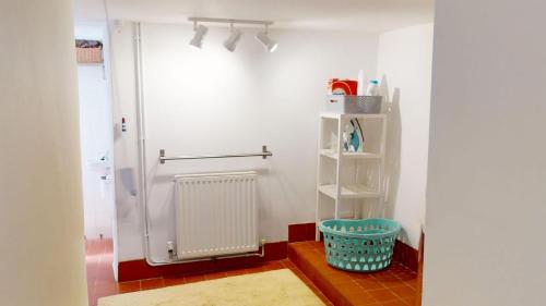 a bathroom with a shower stall and a basket at Georgeham Windsor Cottage 3 Bedrooms in Georgeham