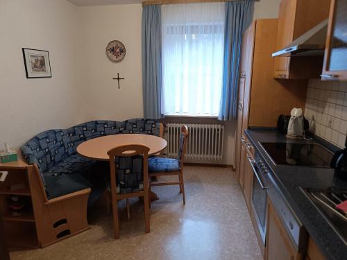 a kitchen with a table and a small table in a room at Gästehaus am Schlossberg in Friedenfels