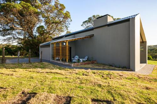 a small house on a hill with a yard at Kragga Kamma Game Park in Port Elizabeth