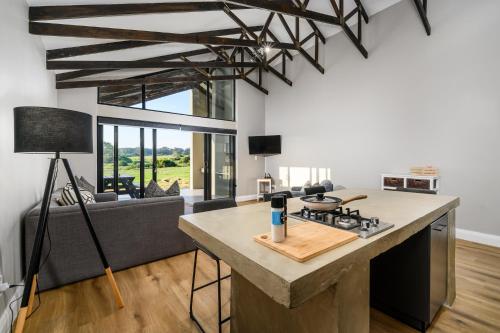 a kitchen and living room with a stove and a couch at Kragga Kamma Game Park in Port Elizabeth