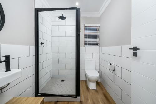 a bathroom with a shower and a toilet at Kragga Kamma Game Park in Port Elizabeth