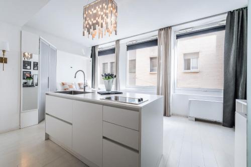 a white kitchen with a sink and a window at The Boutique Houses - Iconic Suite in Galleria Duomo with private parking in Milan