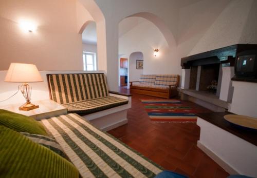a living room with two couches and a fireplace at Appartamenti in Villa e Casali a Giannella in Santa Liberata